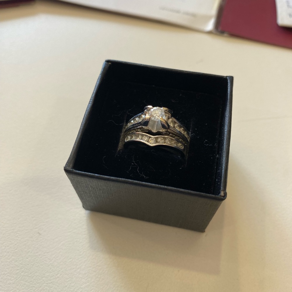 Helzberg “Vivian” white gold engagement ring and matching wedding band.